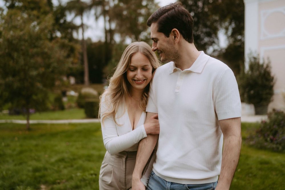 Romantic couple moment captured in casual wear against natural outdoor backdrop.