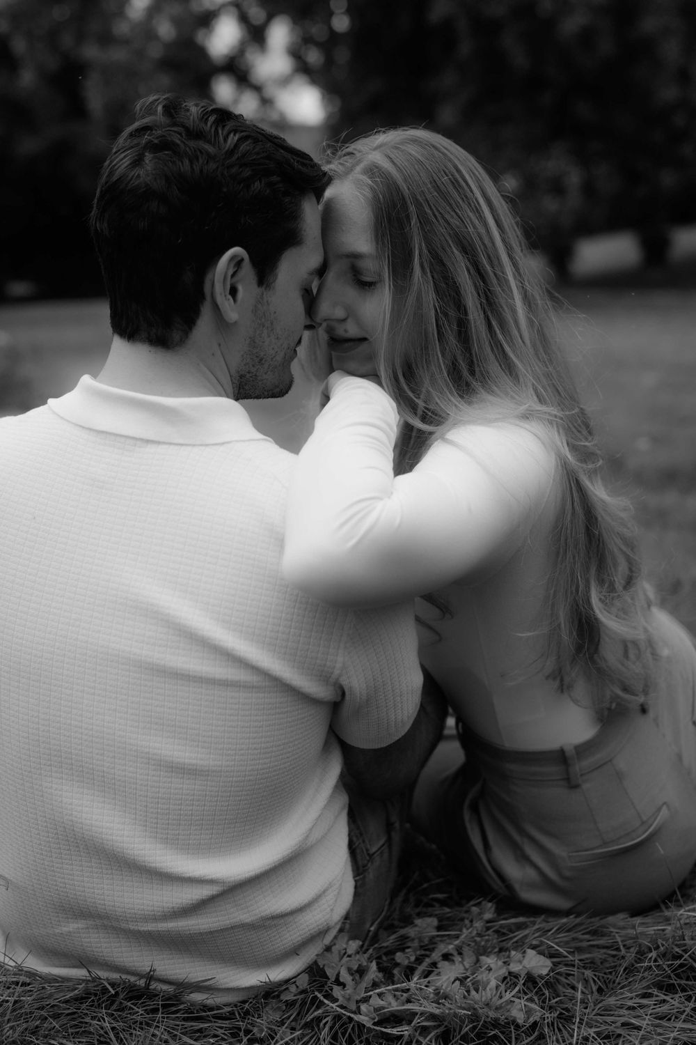 Black and white photo series of a couple sharing tender moments outdoors.