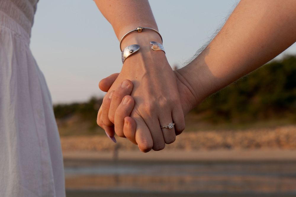 Alex and Kasey are together posing for their engagement photos.
