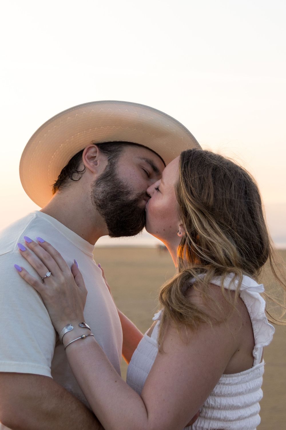 Alex and Kasey are together posing for their engagement photos.