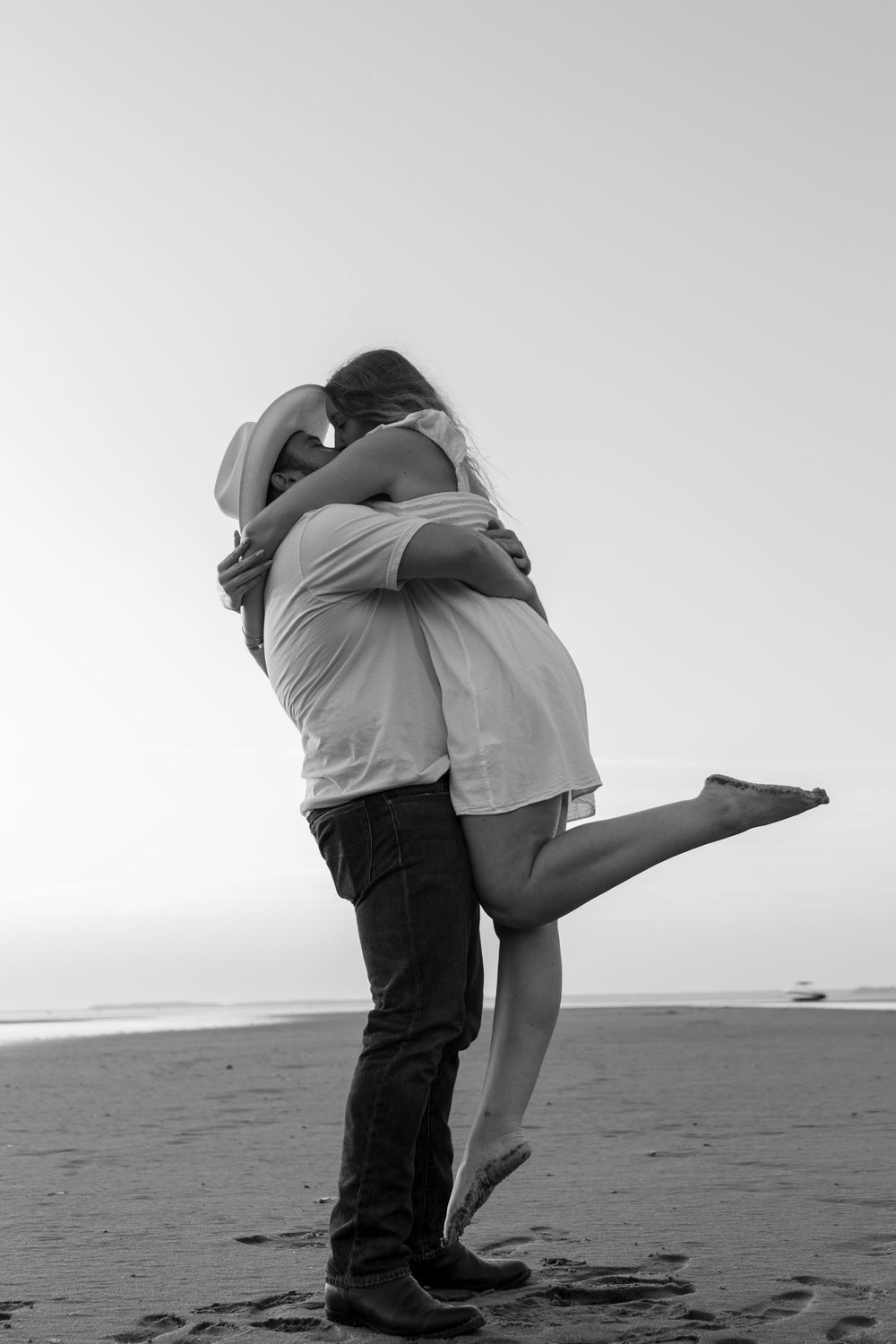 Alex and Kasey are together posing for their engagement photos.