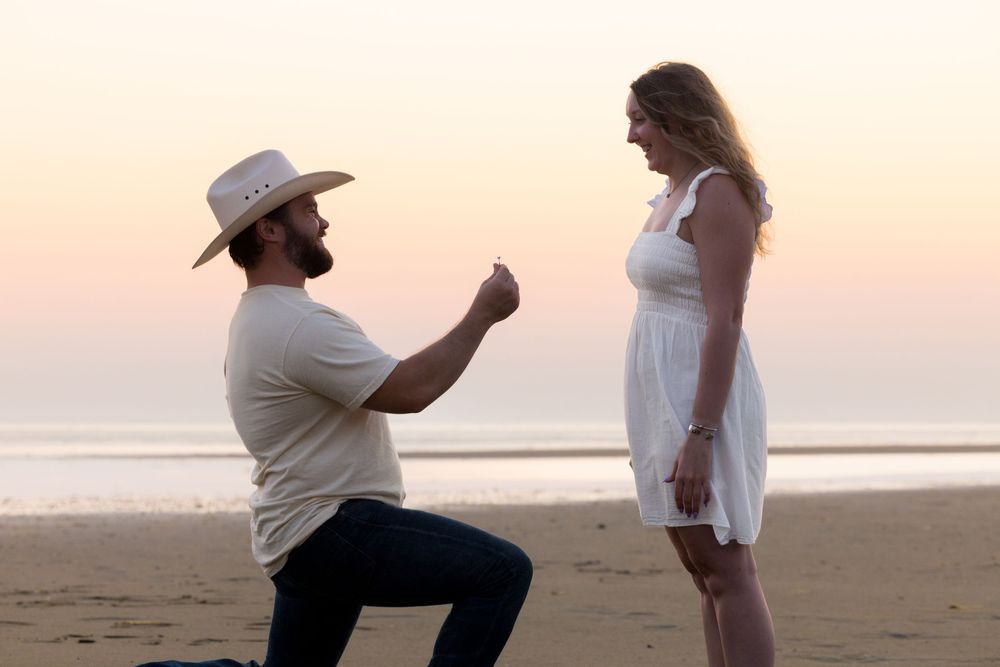 Alex and Kasey are together posing for their engagement photos.