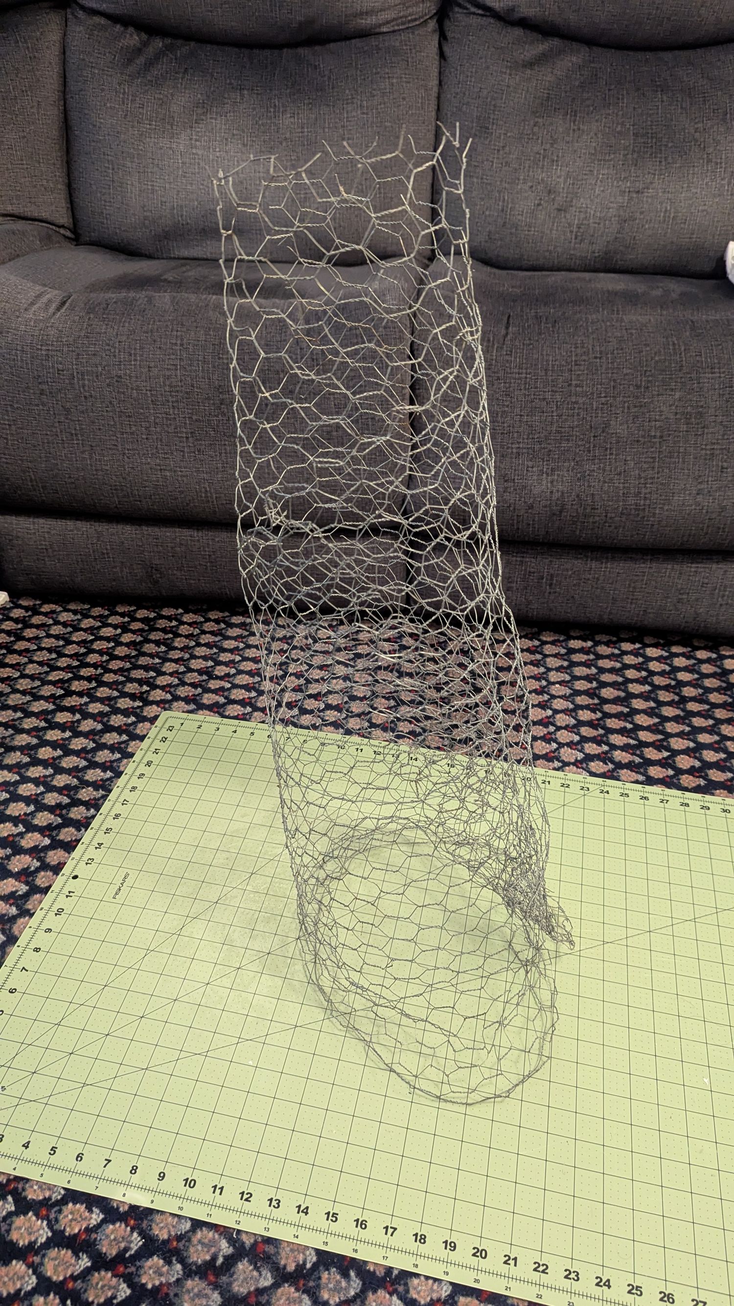 Chicken wire is wrapped in a tube shape.
