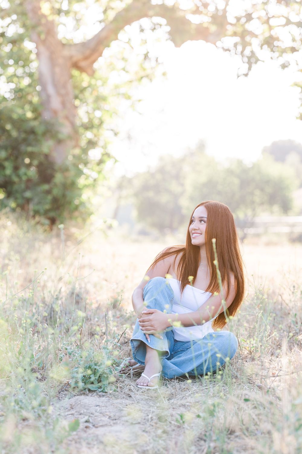 Simi Valley photographer captures Ashlyn in a playful outdoor portrait session at Challenger Park with trees and riverbed backdrops.