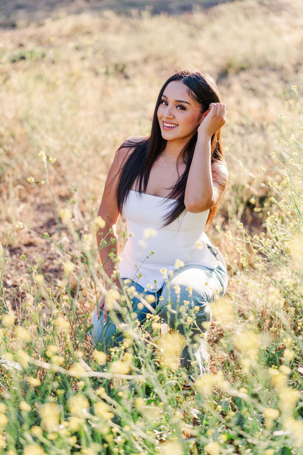 Simi Valley photographer captures Ashlyn in a playful outdoor portrait session at Challenger Park with trees and riverbed backdrops.