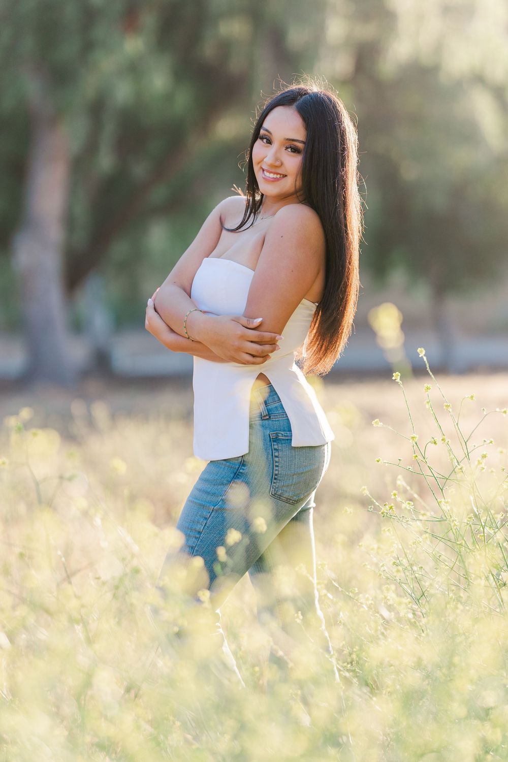 Simi Valley photographer captures Ashlyn in a playful outdoor portrait session at Challenger Park with trees and riverbed backdrops.