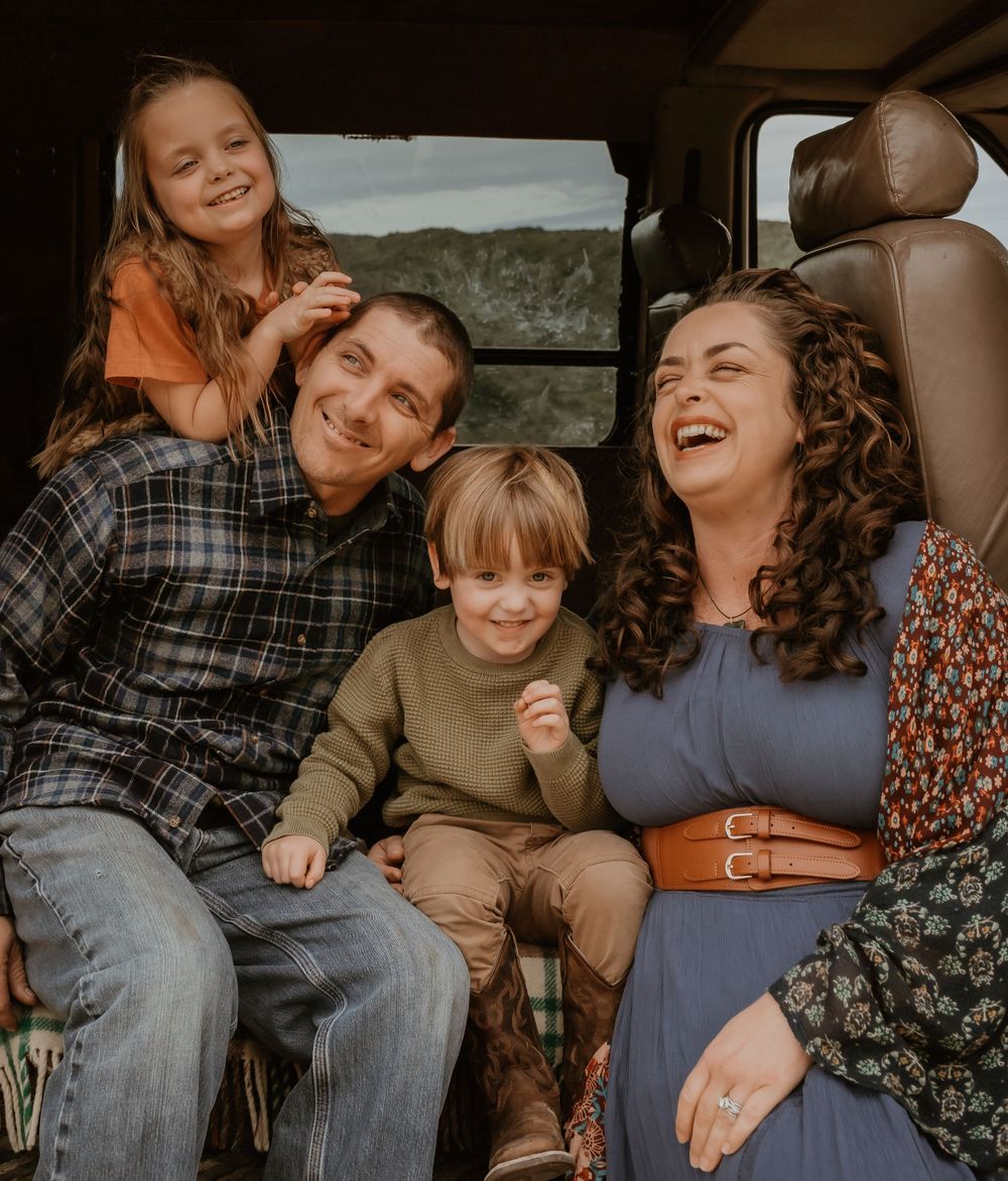 A candid moment captured inside a van as a group shares laughter together during a road trip adventure.
