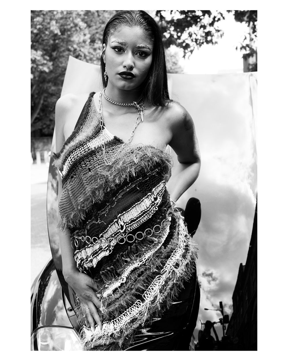 Black and white fashion photo showcasing textured strapless gown with intricate details.