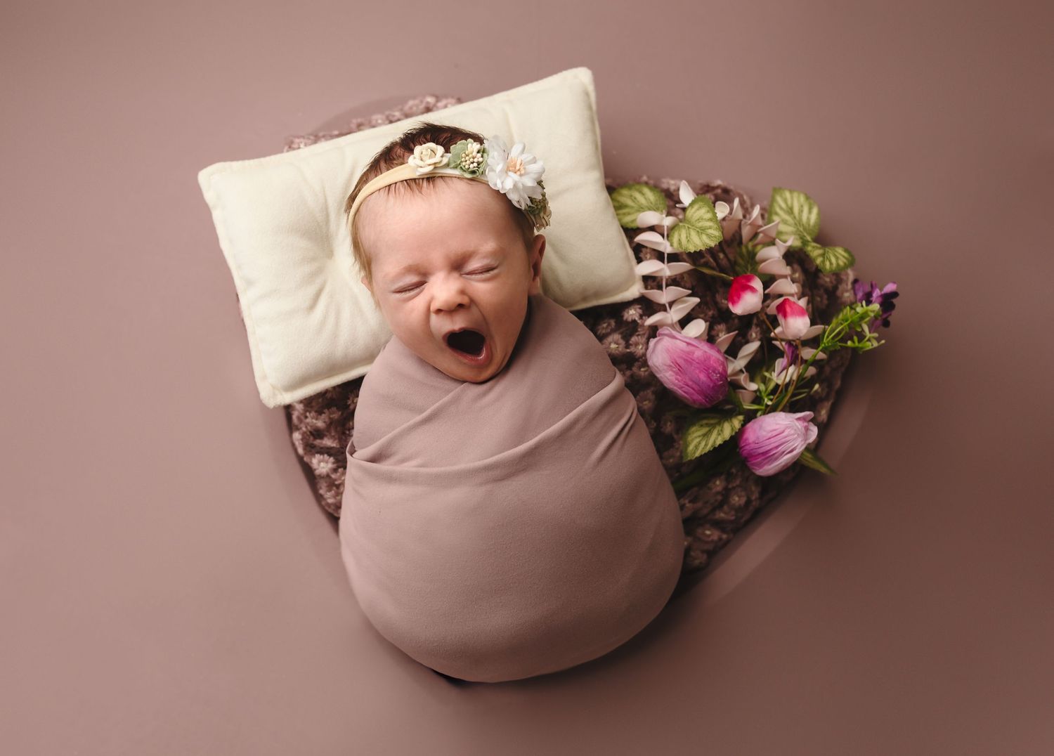 Charlottesville photographer, newborn, baby, maternity, family, yawning baby girl wrapped in eggplant purple and sleeping in heart basket.