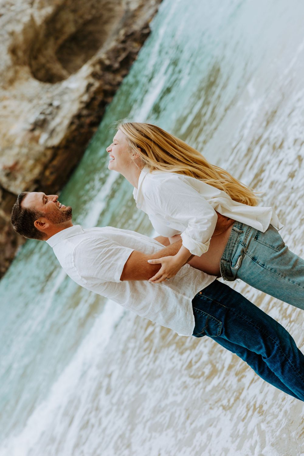 Person in white shirt and jeans dances gracefully near a waterfall in a dynamic photo sequence.