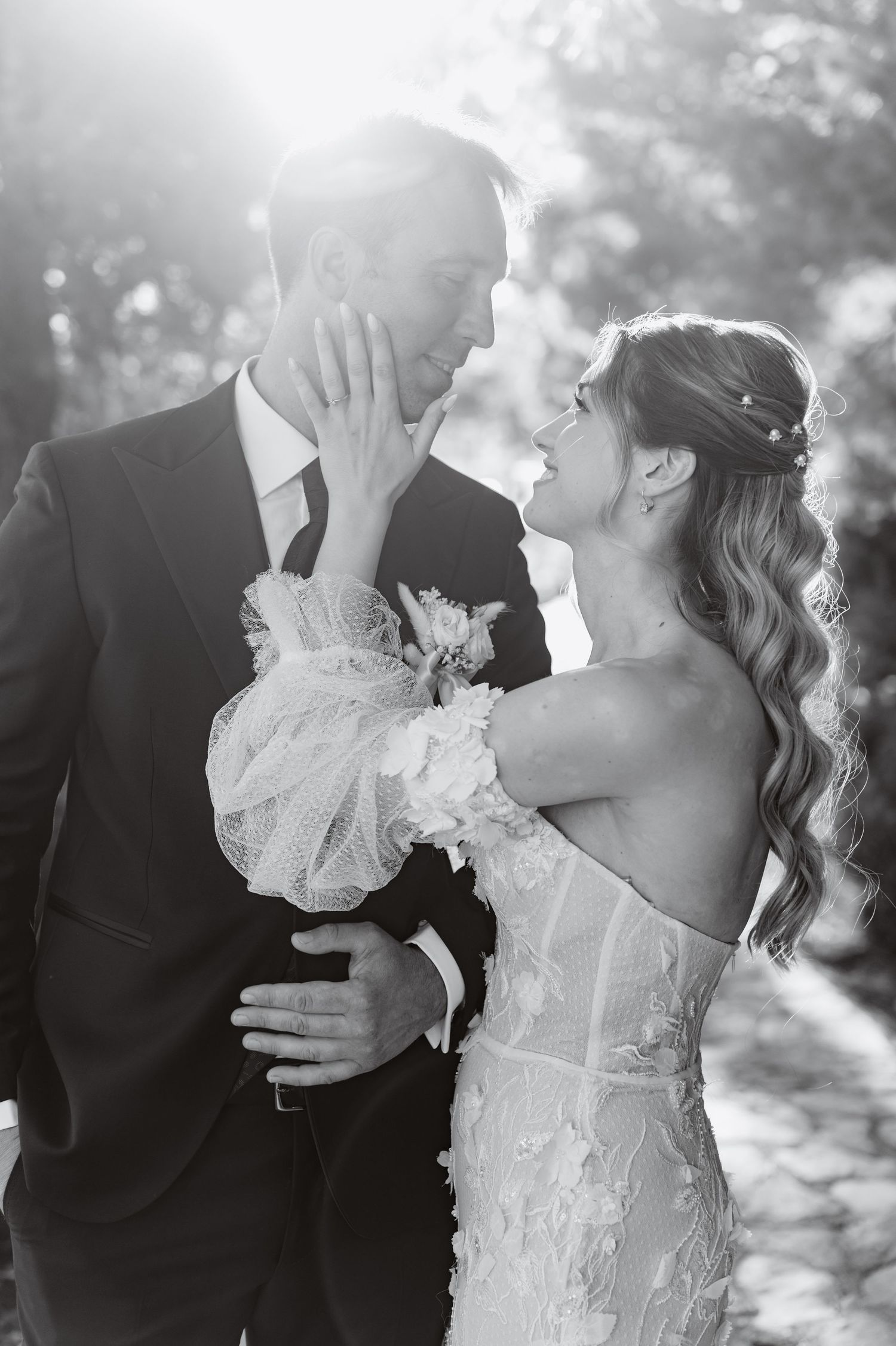 A dreamy black and white wedding photo showing a loving couple sharing an intimate moment in soft natural light.