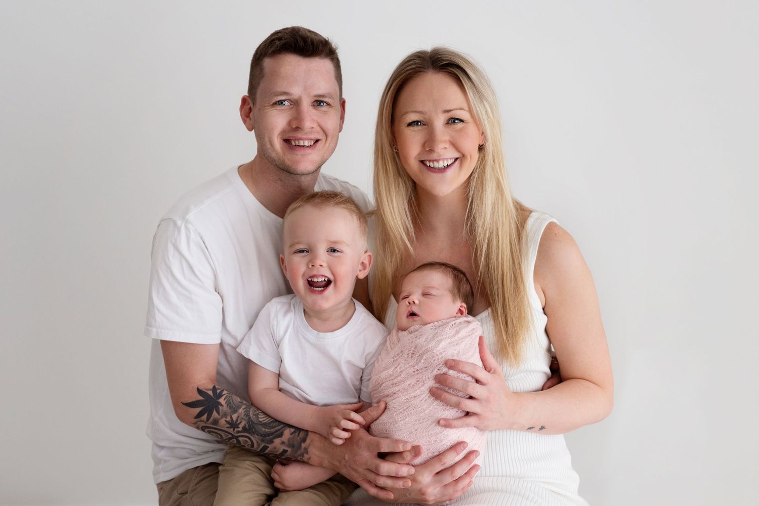 Happy family portrait series with baby on white background.