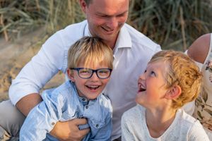 A heartwarming moment of laughter shared on a sunny beach day.