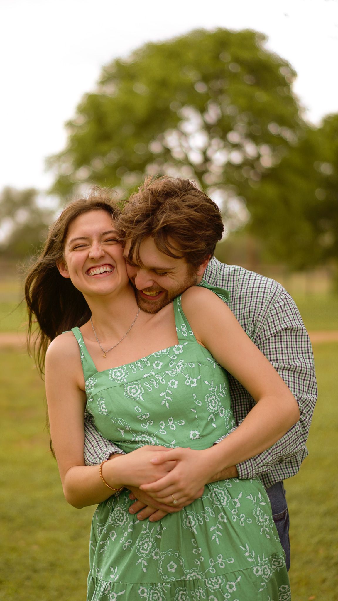 A tender romantic moment showing two people in an intimate embrace, with a diamond engagement ring.