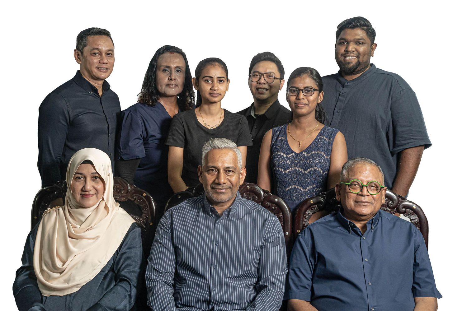 Group portrait of diverse medical team members against white background.