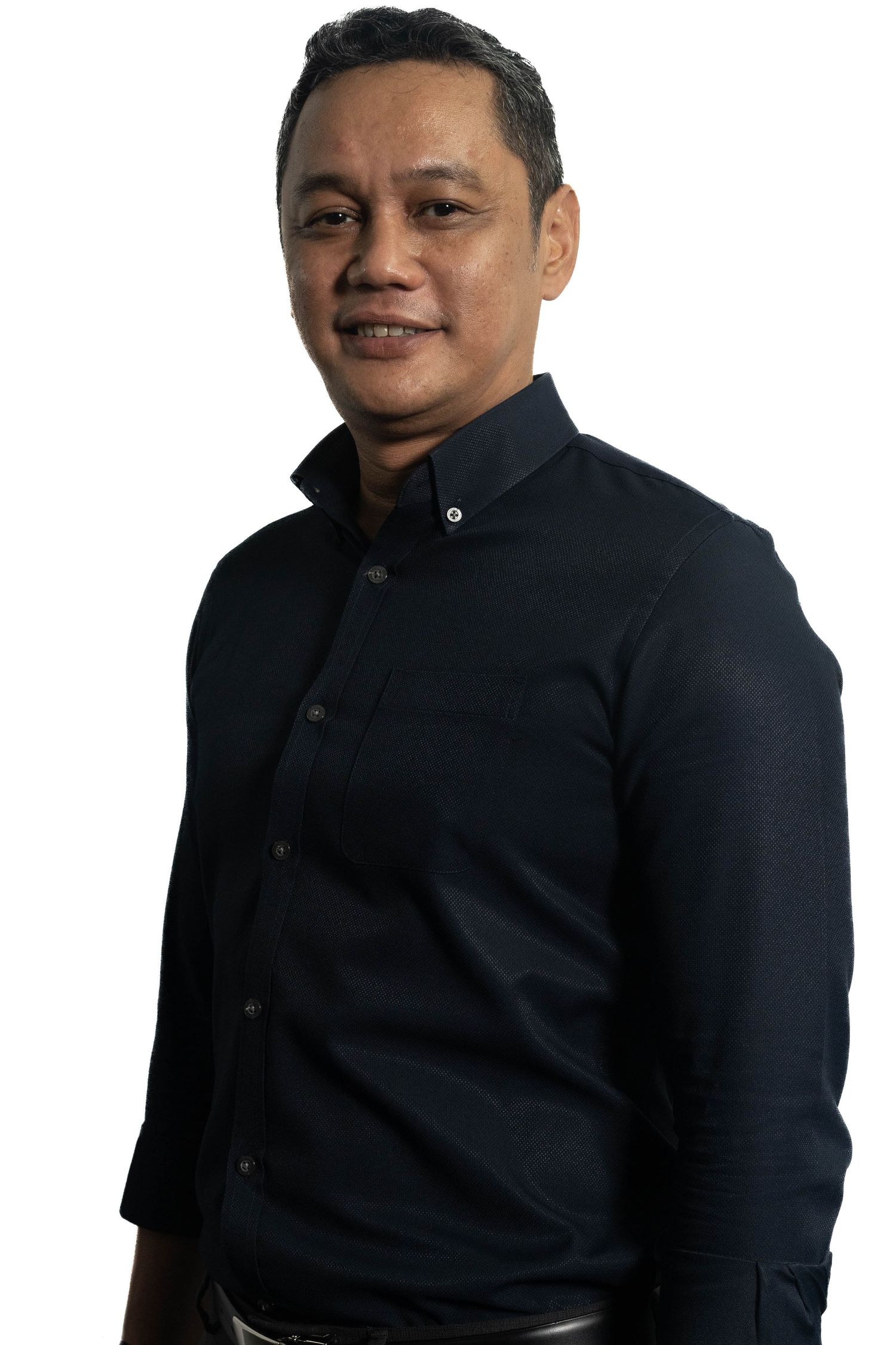 Professional portrait of person in dark button-down shirt against white background.
