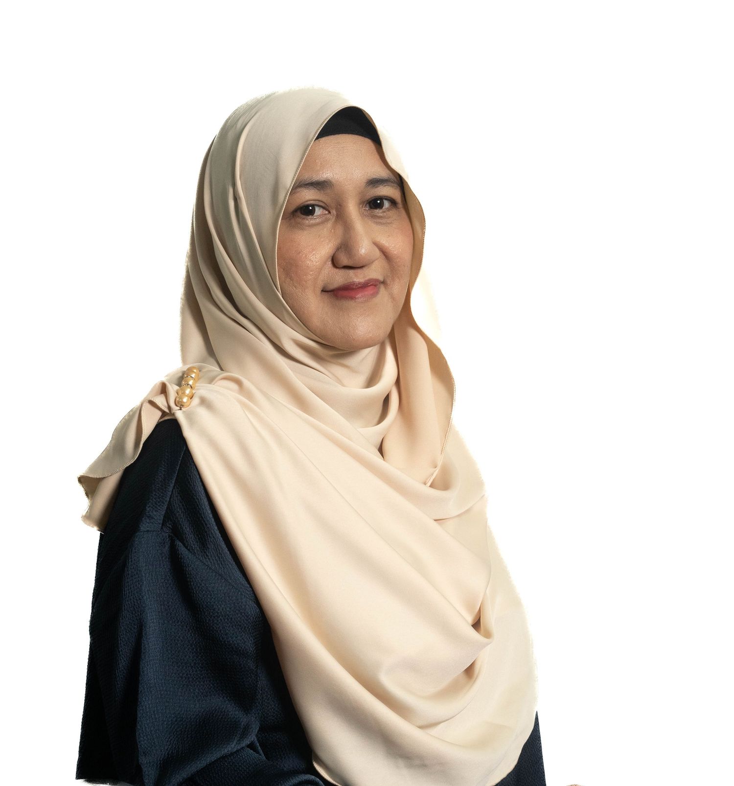 Professional portrait of person wearing cream hijab and navy top against white background.