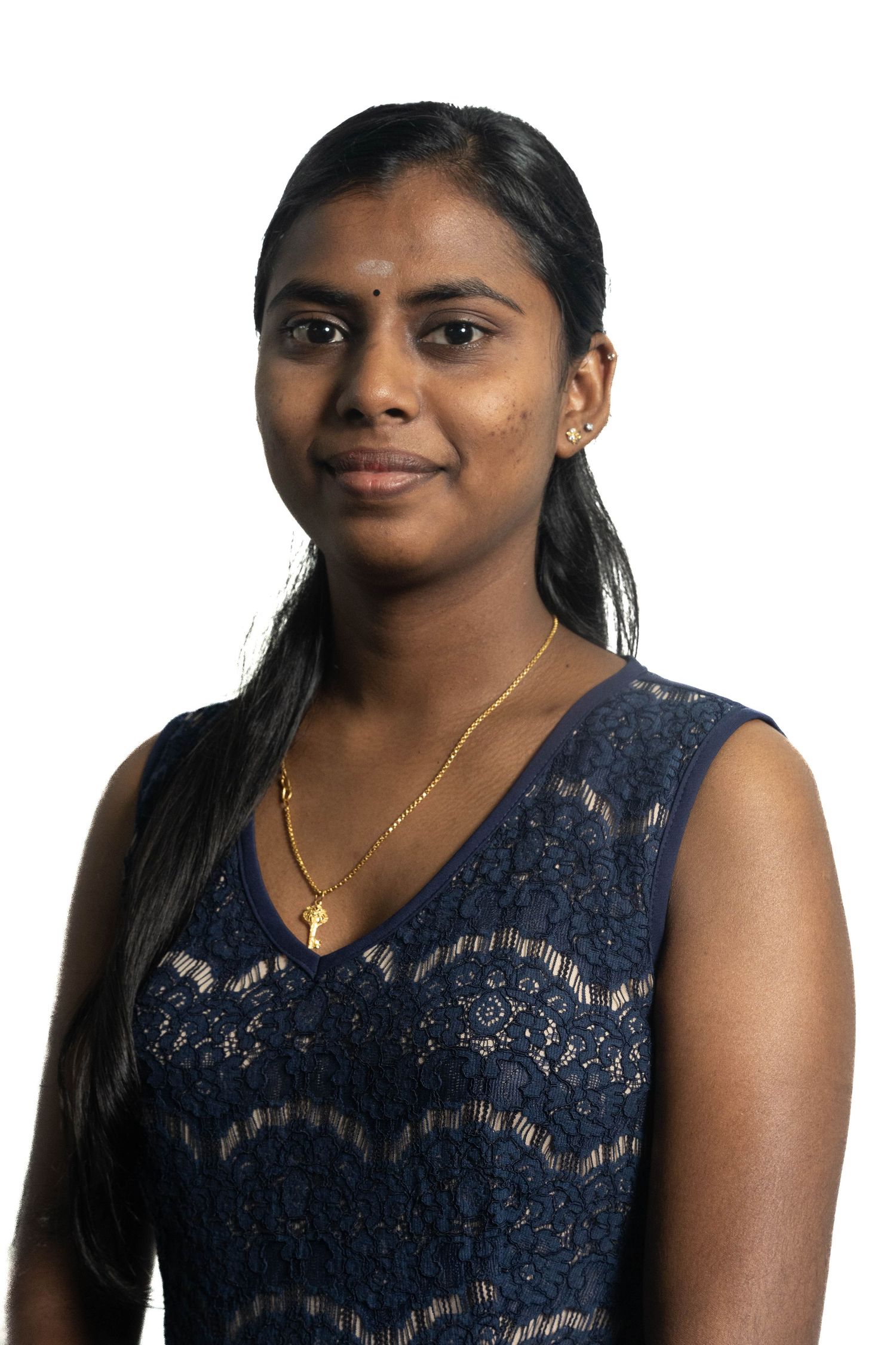 Professional portrait of person in navy lace formal dress against white background.