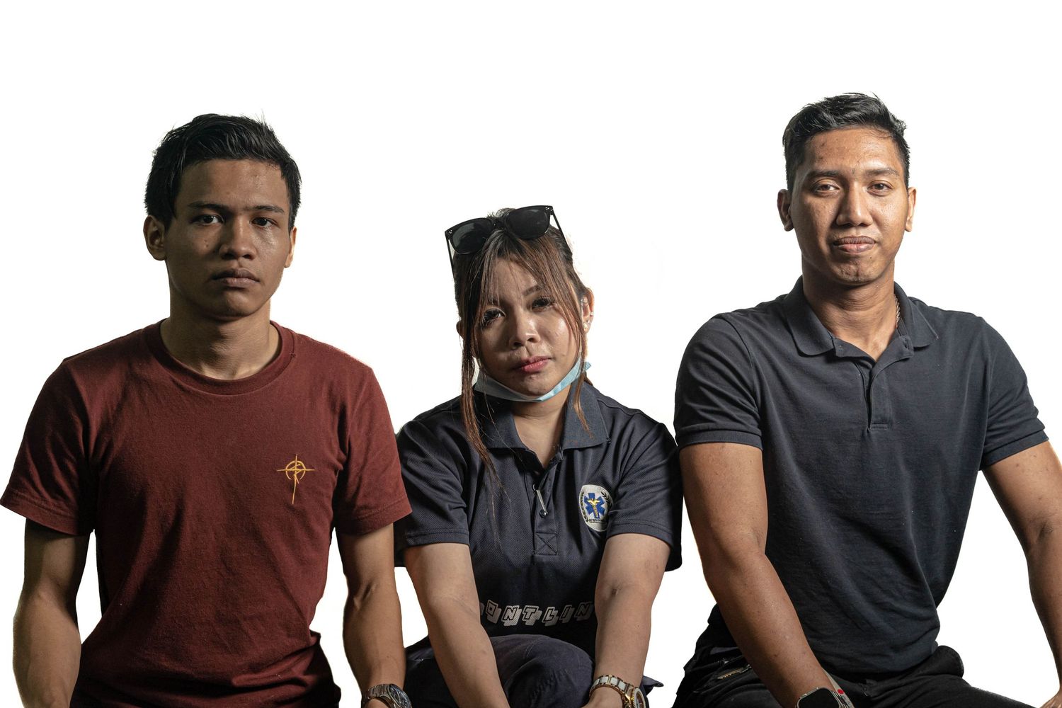 Three healthcare professionals standing together against white background.