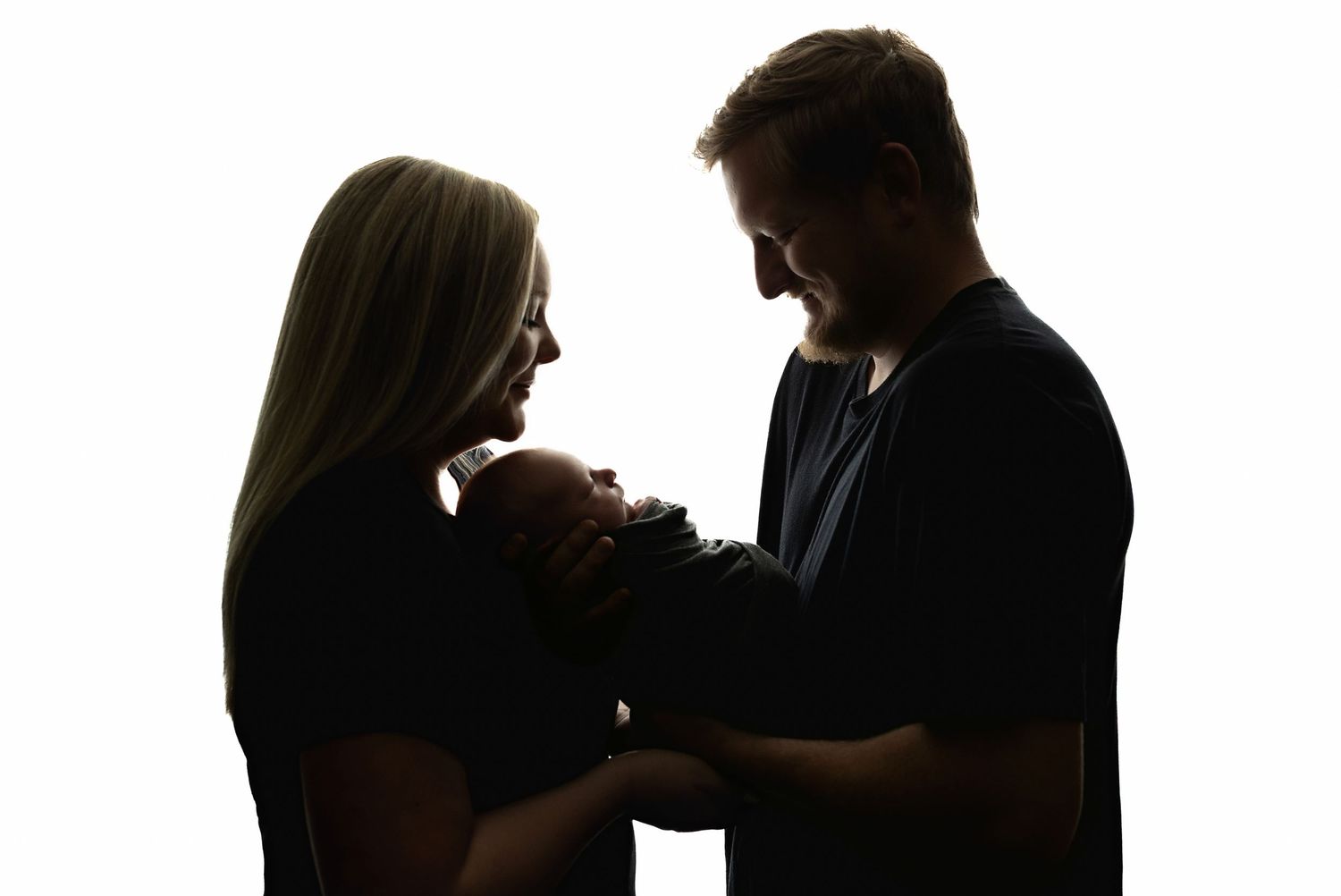 A back lit image with mom, dad, and baby. Greenville sc newborn photographer, Easley sc newborn photographer, Upstate newborn photographer,