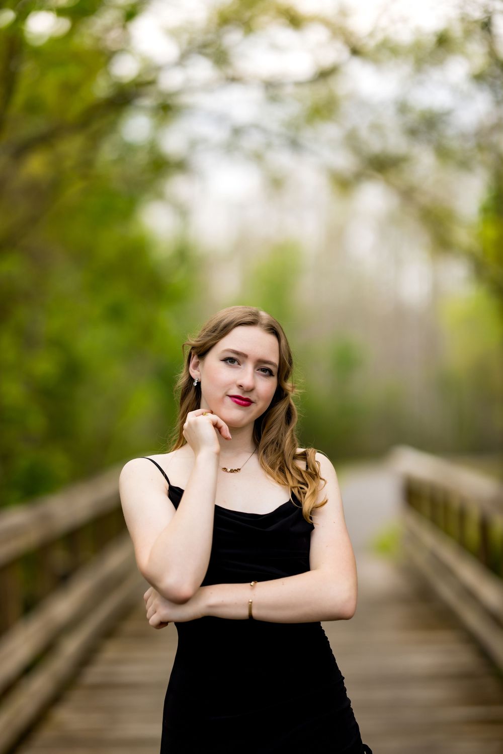 A series of portraits taken on a wooden boardwalk surrounded by lush green foliage in soft natural lighting.