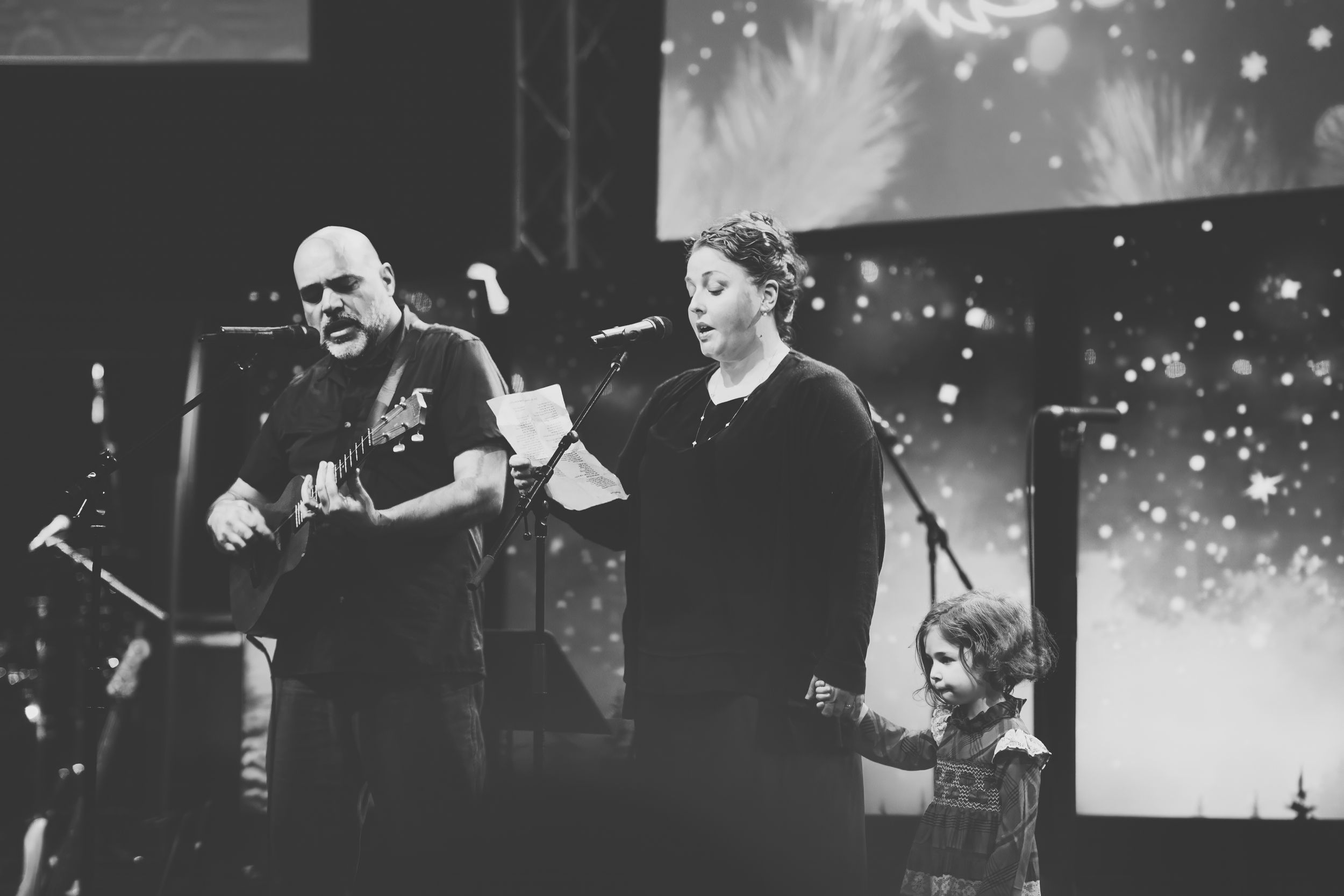 Black and white concert performance photos showing musicians on stage with dramatic lighting and crowd silhouettes.