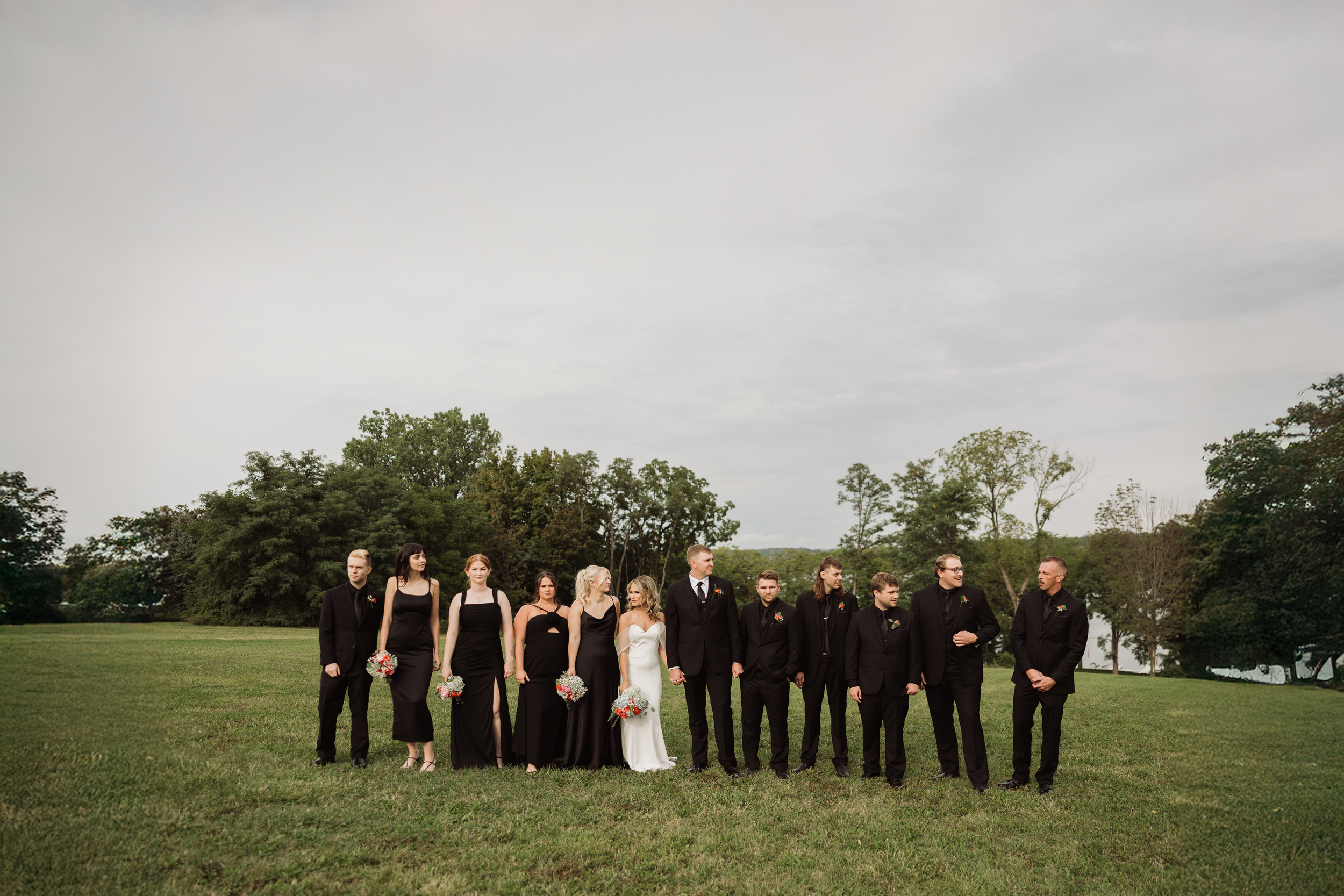 Bridesmaids and groomsmen standing with newlyweds after ceremony in Auburn NY