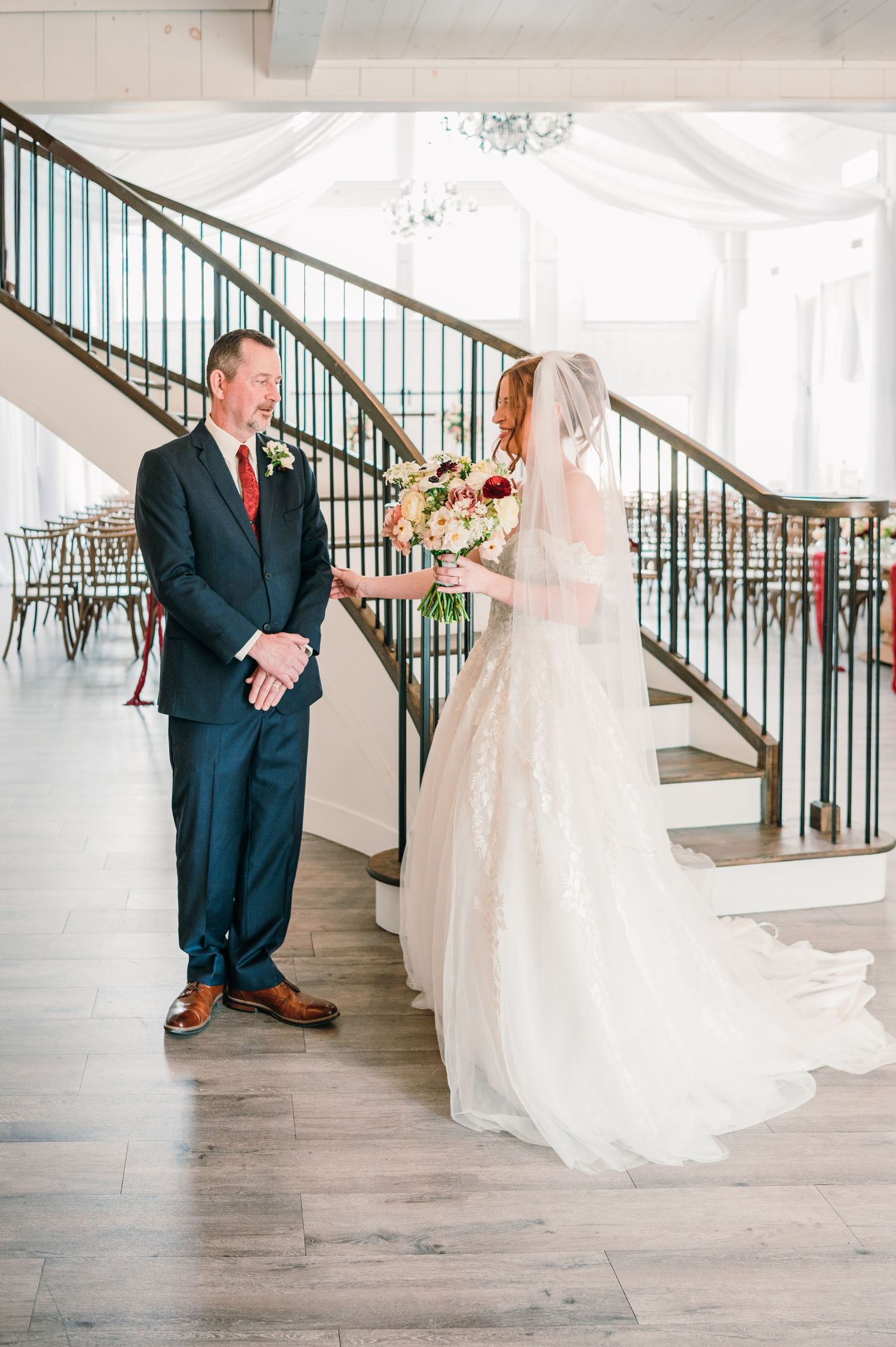 A series of wedding photos showing a first look moment between a bride and groom on an elegant staircase.