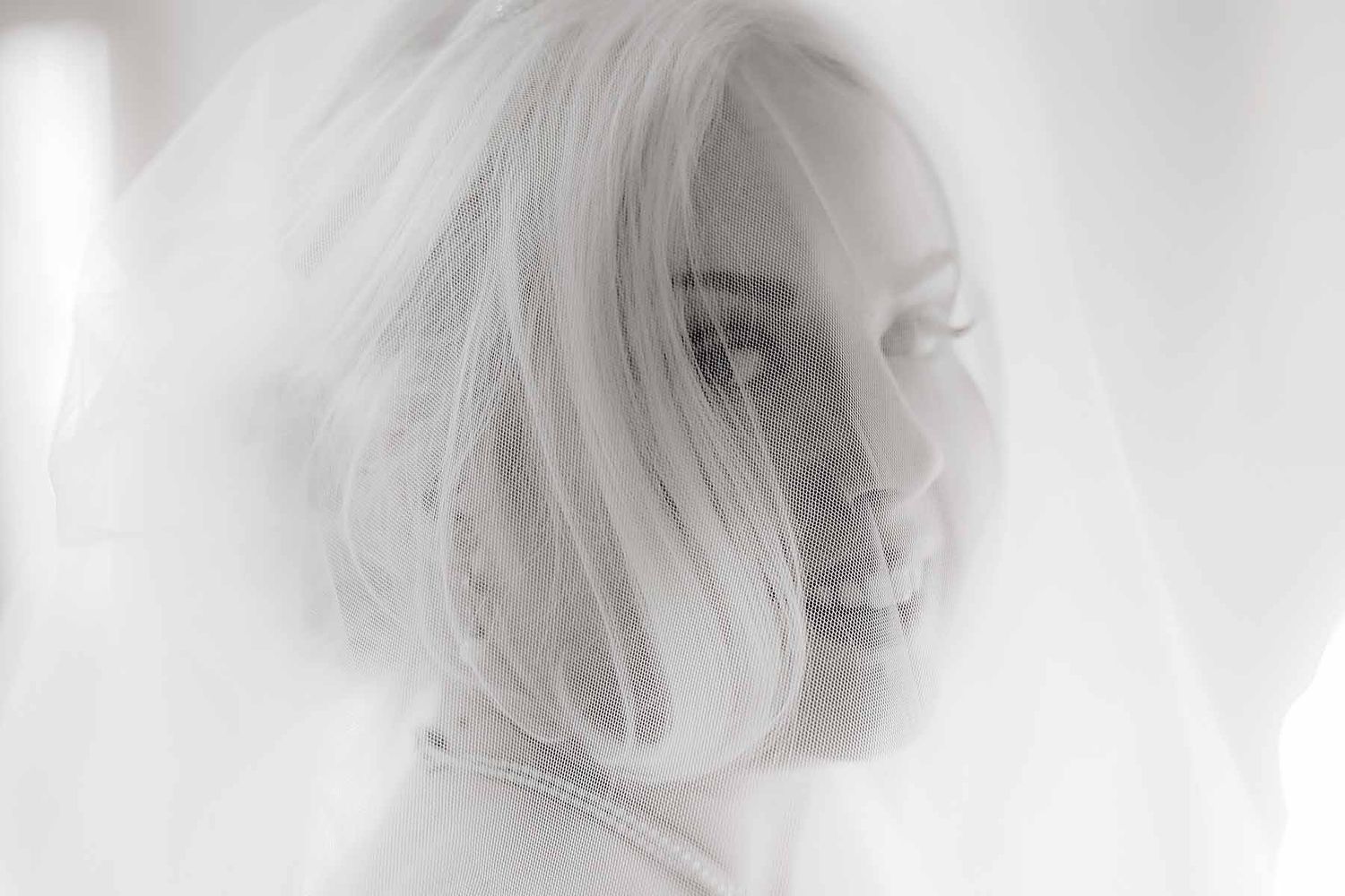Black and white artistic portrait series showing ethereal side profile views with soft focus and motion blur effects.