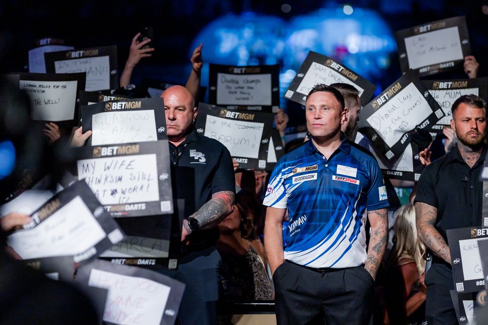 A group of law enforcement officers standing in a crowd holding various signs and placards.