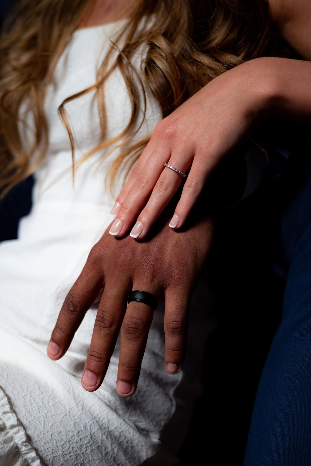 Close-up shots of hands wearing wedding rings against a white background.