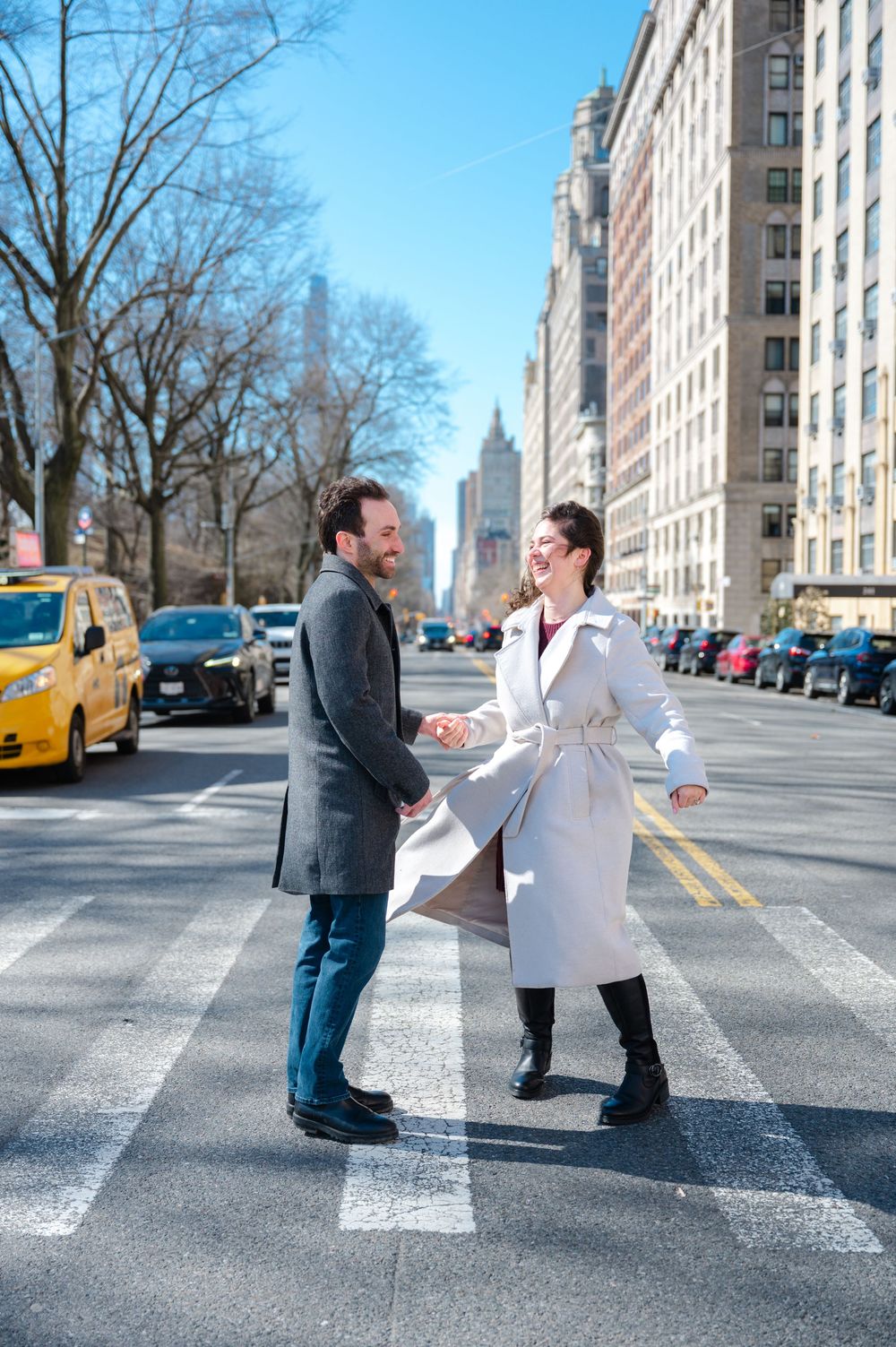 A couple recreates the iconic Beatles Abbey Road album cover pose on a crosswalk in New York City.