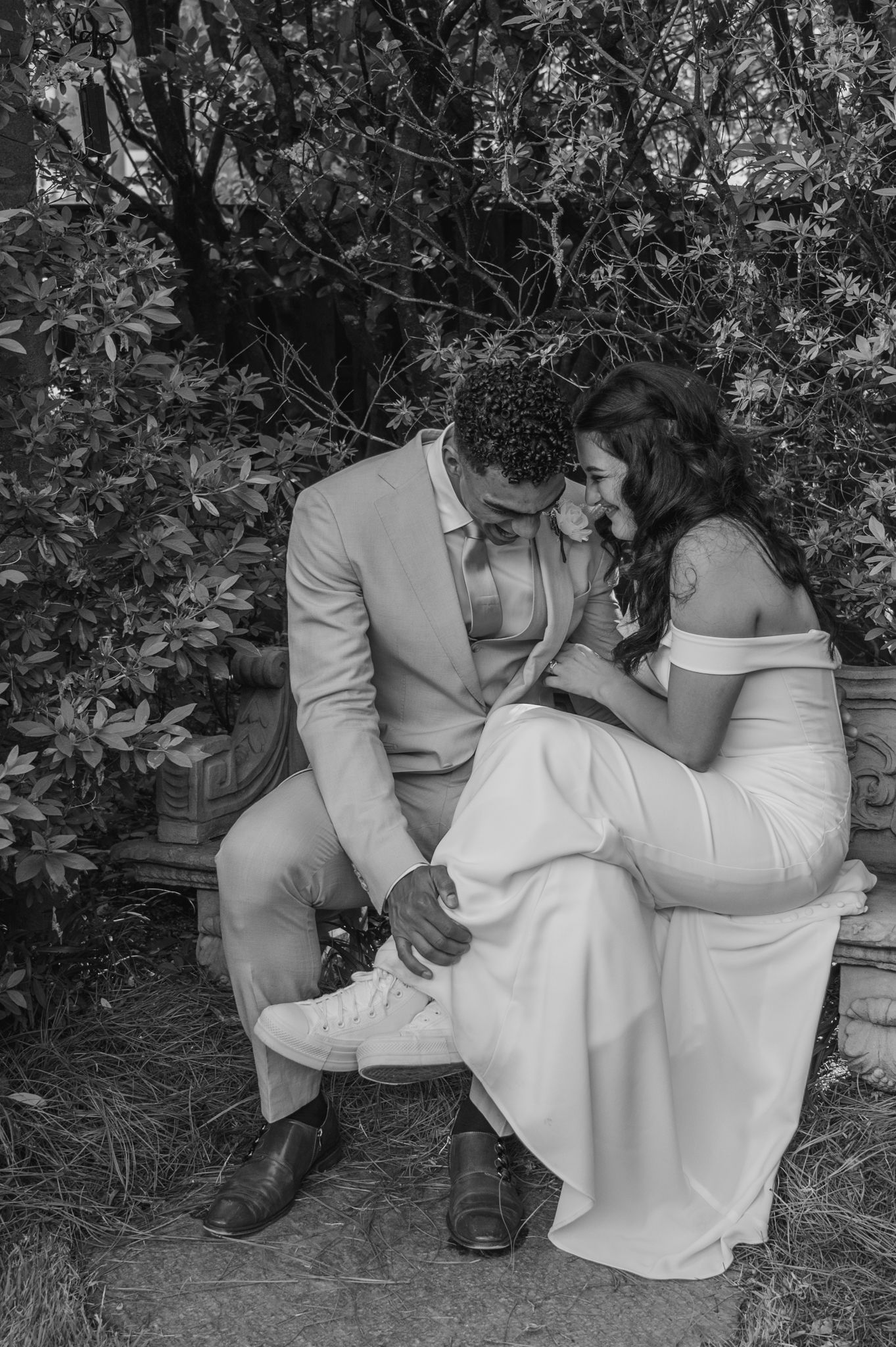 A black and white photo sequence showing a couple in formal attire sitting together outdoors among foliage.
