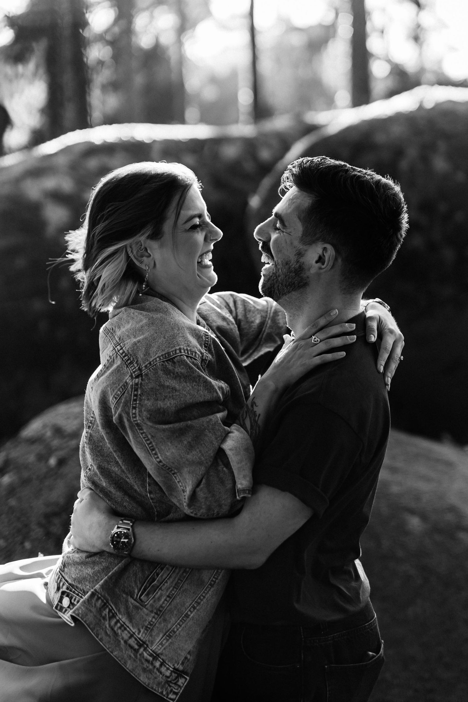 Black and white candid portrait of joyful couple laughing during pre-wedding photoshoot in Sintra, Portugal