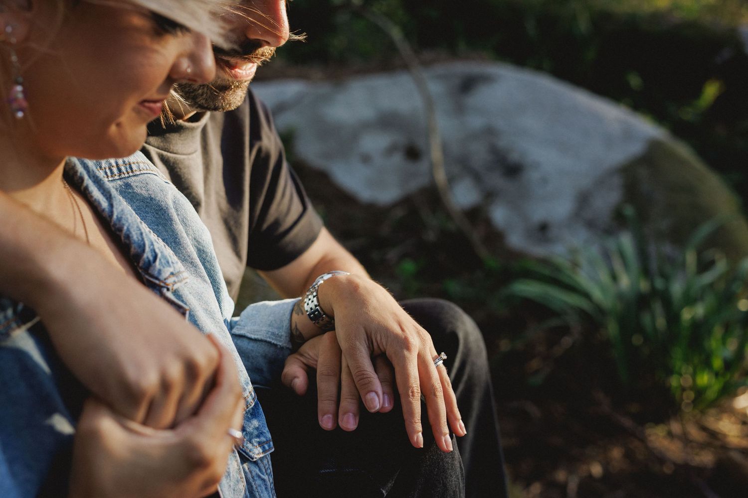 Detail of couple holding hands with engagement ring during pre-wedding session in Sintra, Portugal