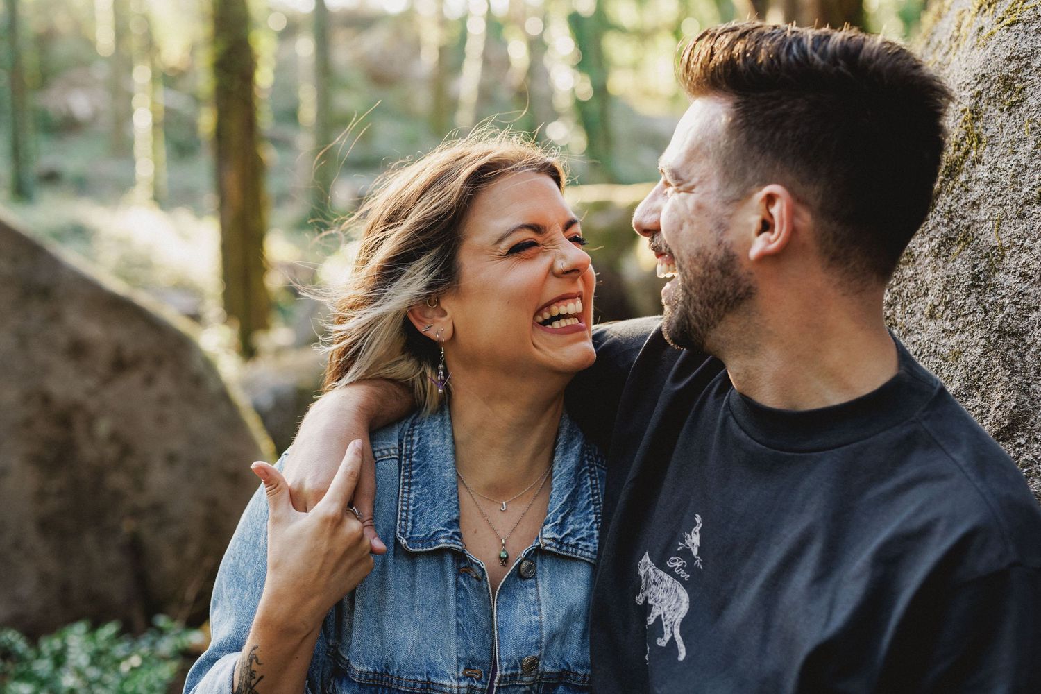 Close-up portrait of couple laughing together during natural light engagement session in Sintra, Portugal