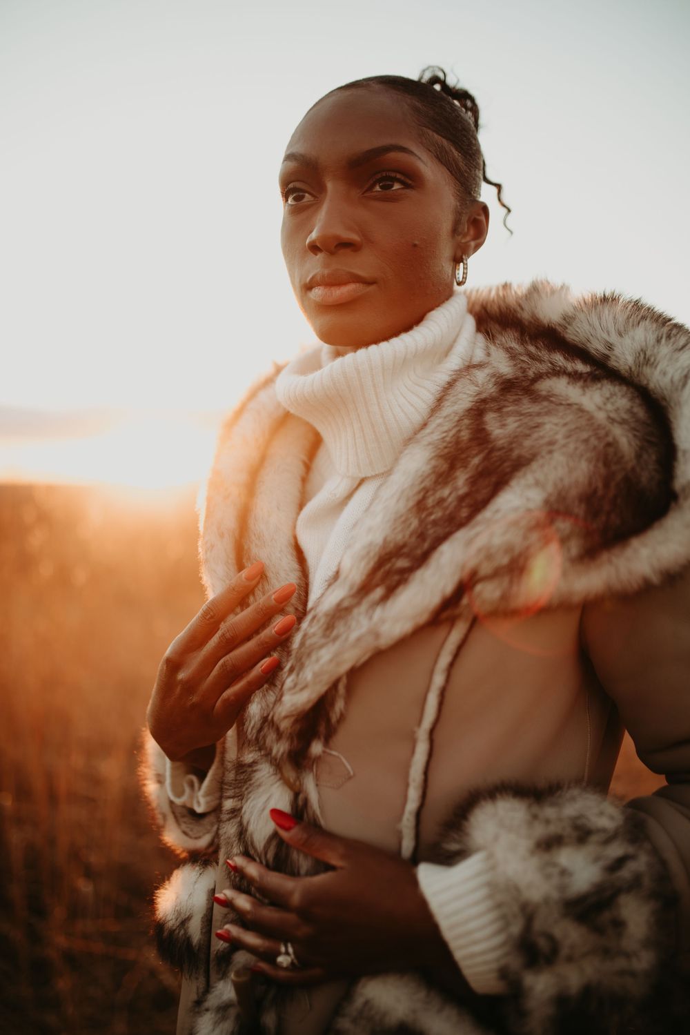 Warm-toned fashion portraits featuring cozy winter wear with fur trim against sunset lighting.
