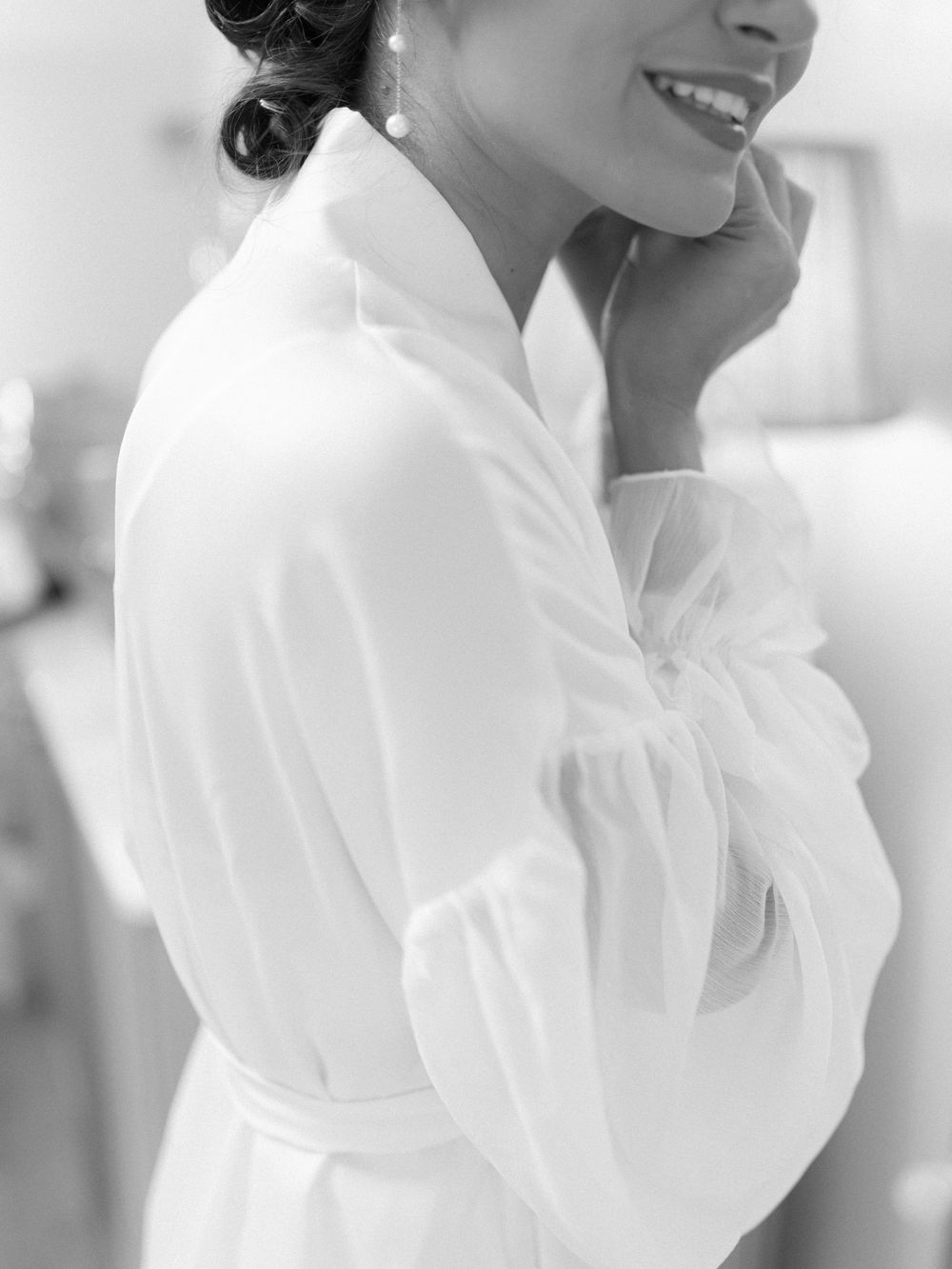 A series of black and white portraits showing a person in an elegant white ruffled blouse against a light background.