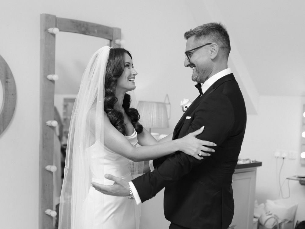 A black and white wedding photo collage showing tender moments between a couple during their celebration.