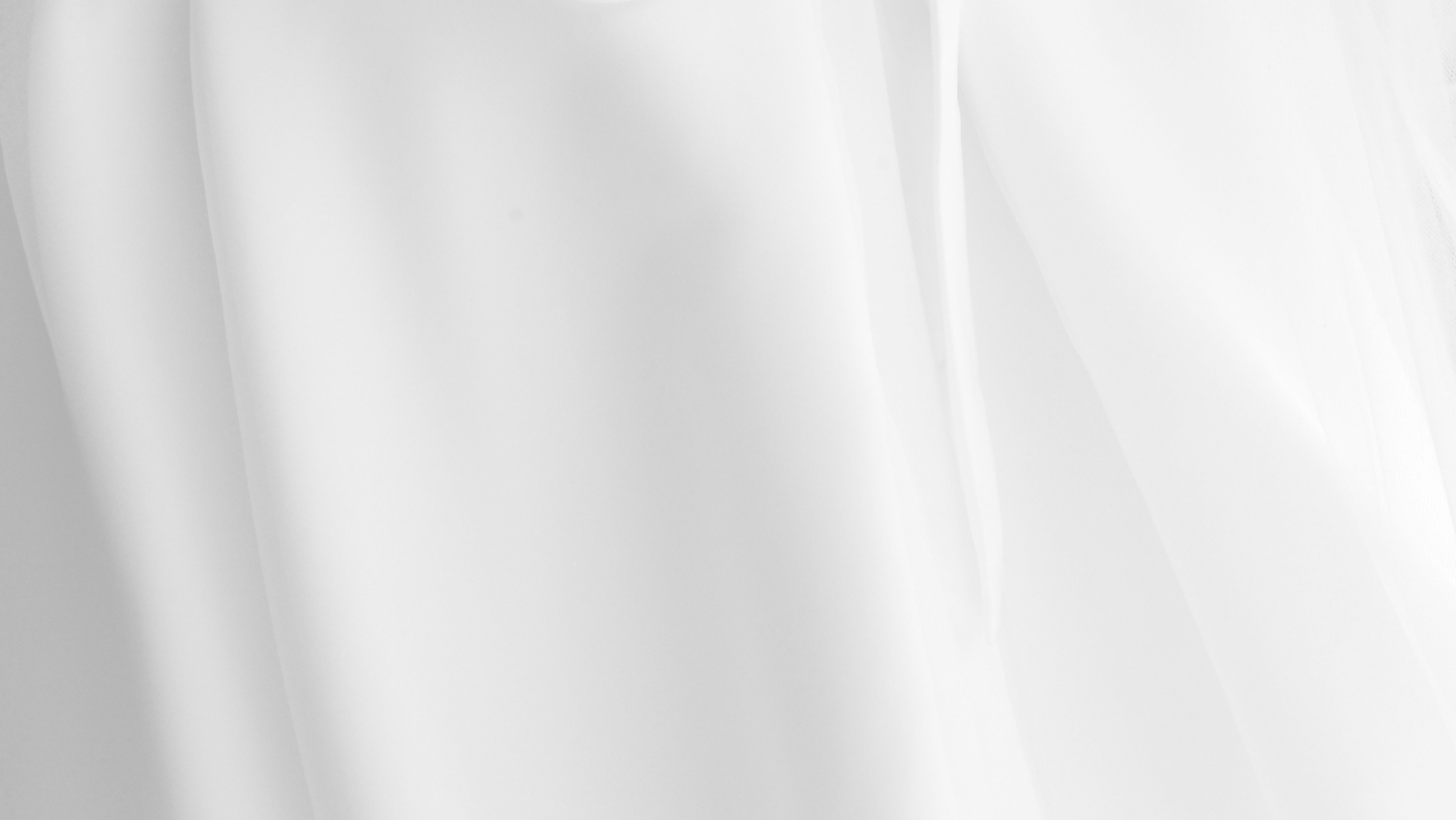 Smooth white fabric texture with soft flowing folds and subtle shadows.