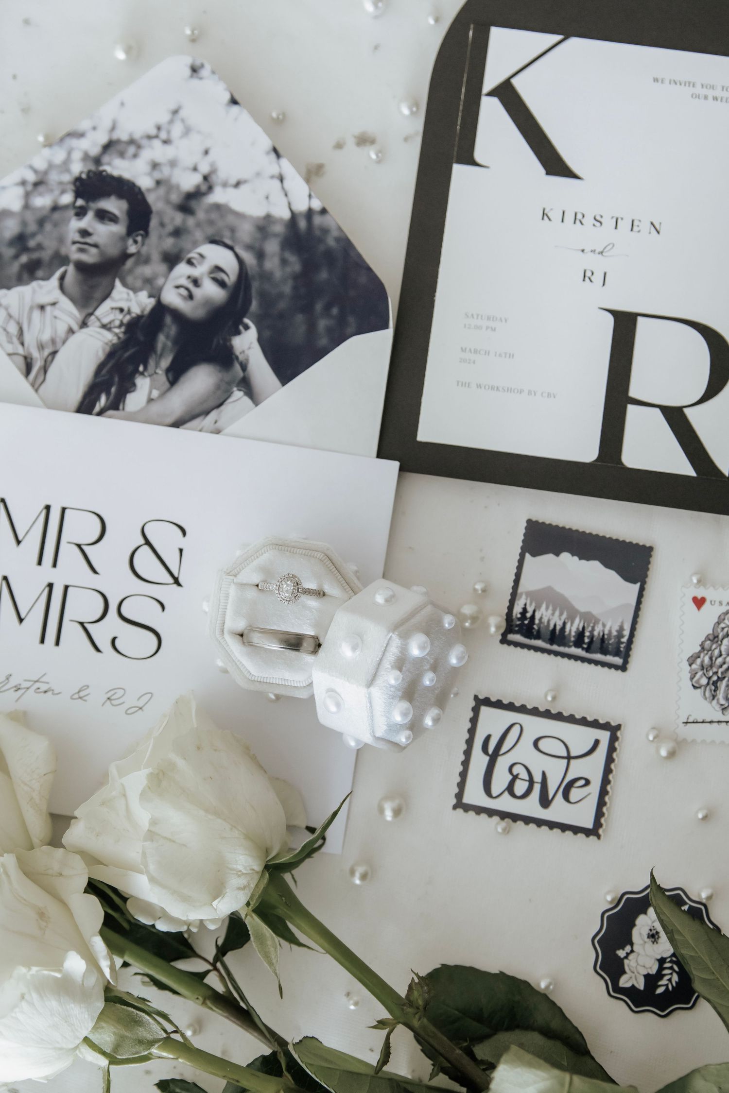 Detail photo of wedding invitations, save the dates, wedding rigngs, and flowers