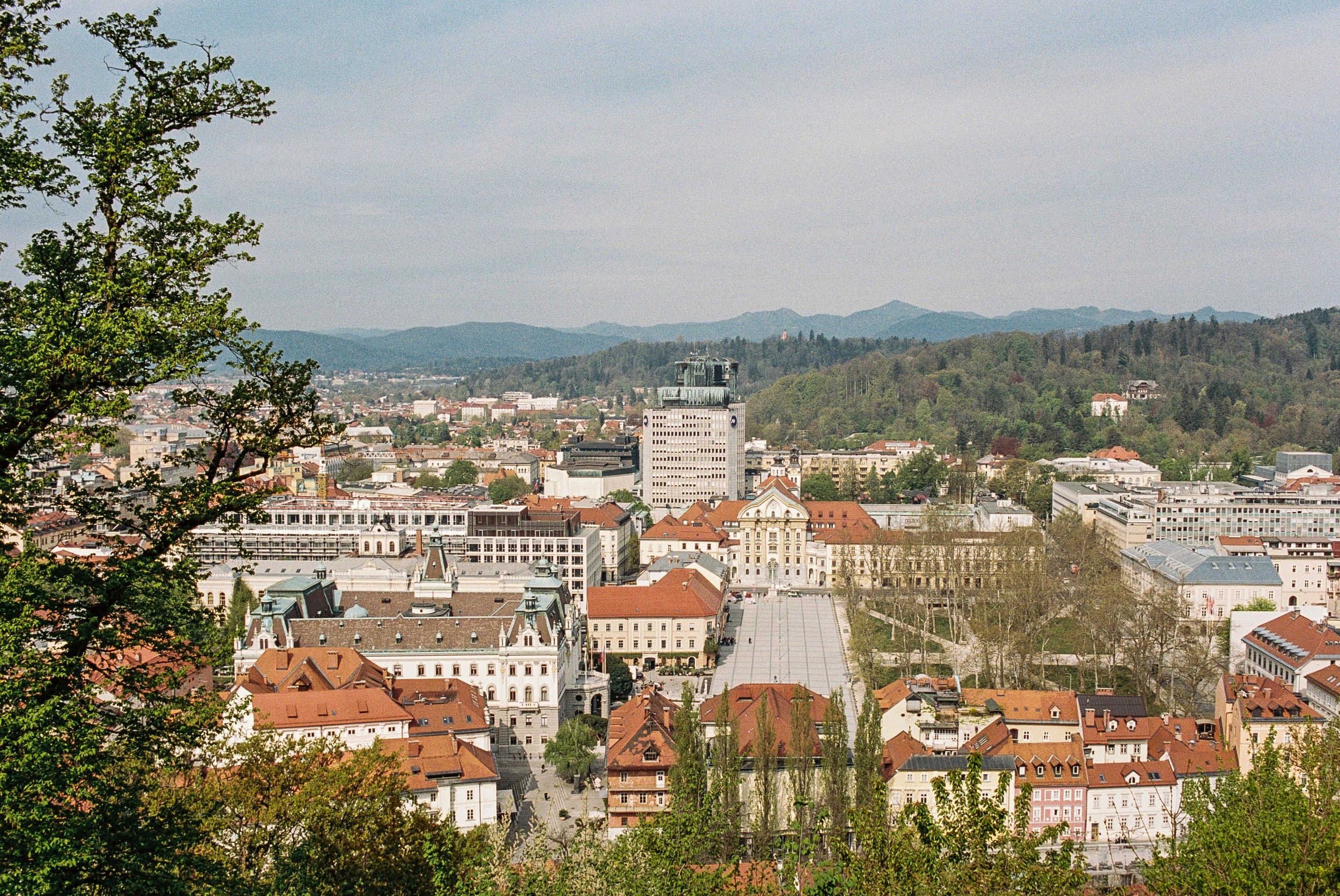 A picturesque view of Ljubljana, Slovenia, featuring the iconic Triple Bridge, Ljubljana Castle, and the charming Old Town. Discover the bes