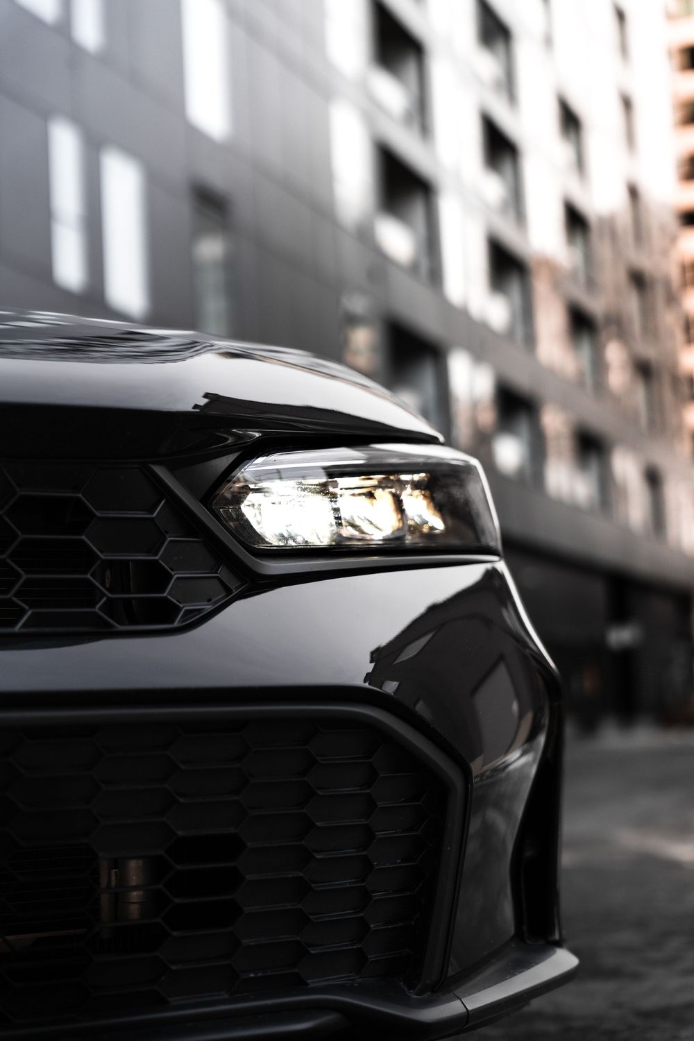 Detail shot of modern Honda LED headlight and aggressive front grille design. Mtlshutter photography