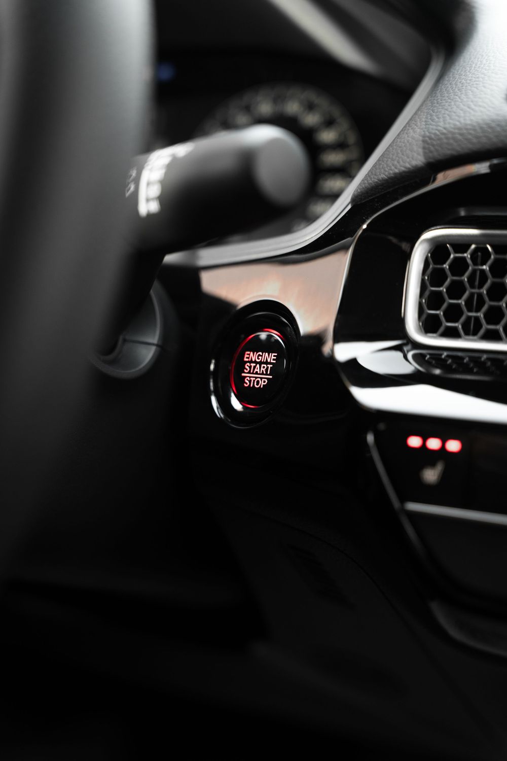 Close-up of Honda push-start button in dark vehicle interior. Mtlshutter photography