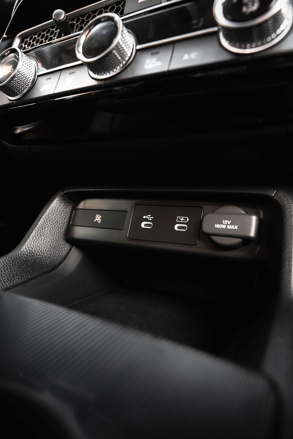 Close-up view of modern car control buttons and dials in black interior. Mtlshutter photography