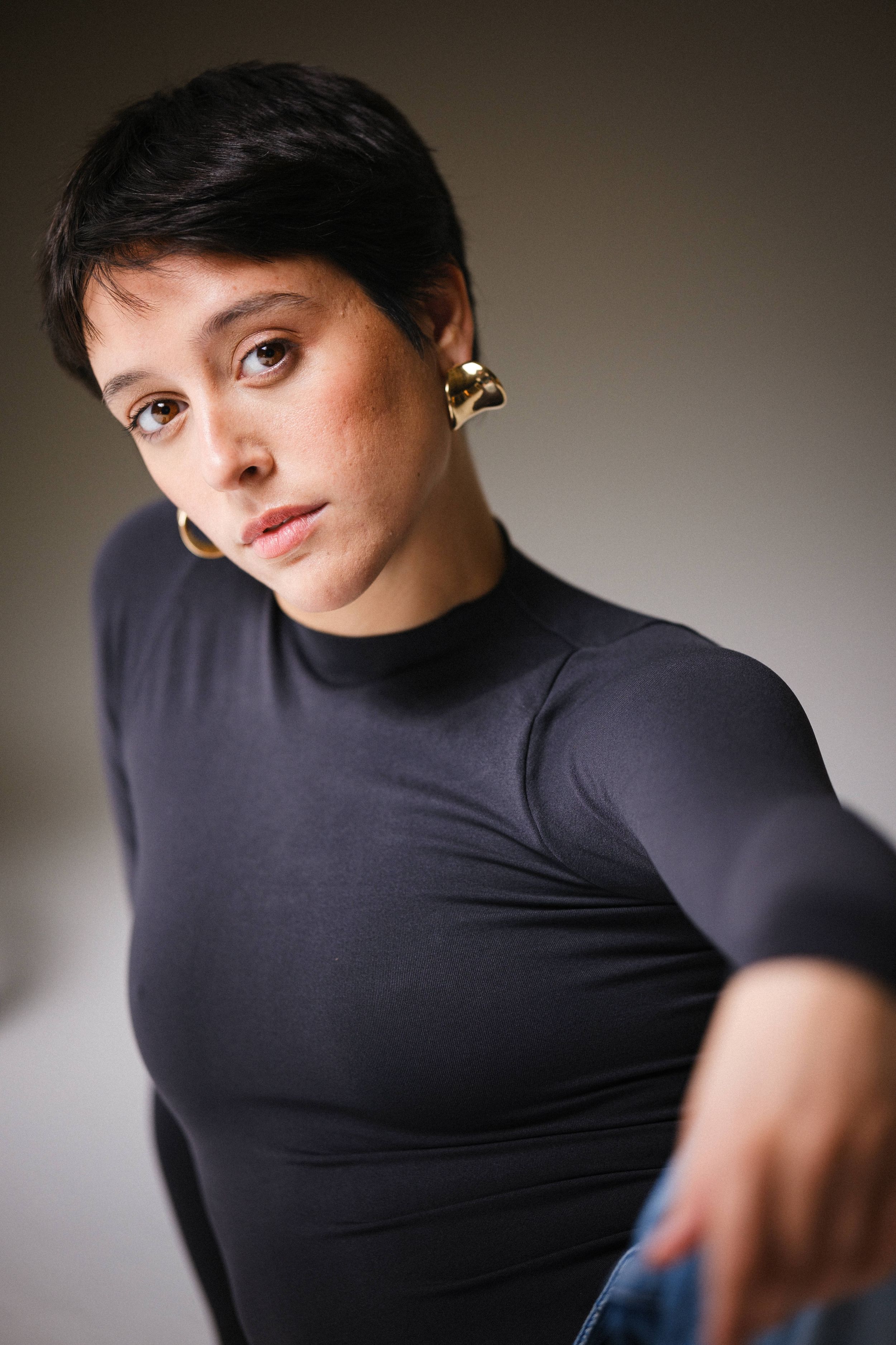 Artistic portrait series in black turtleneck showing dynamic movement and expression.