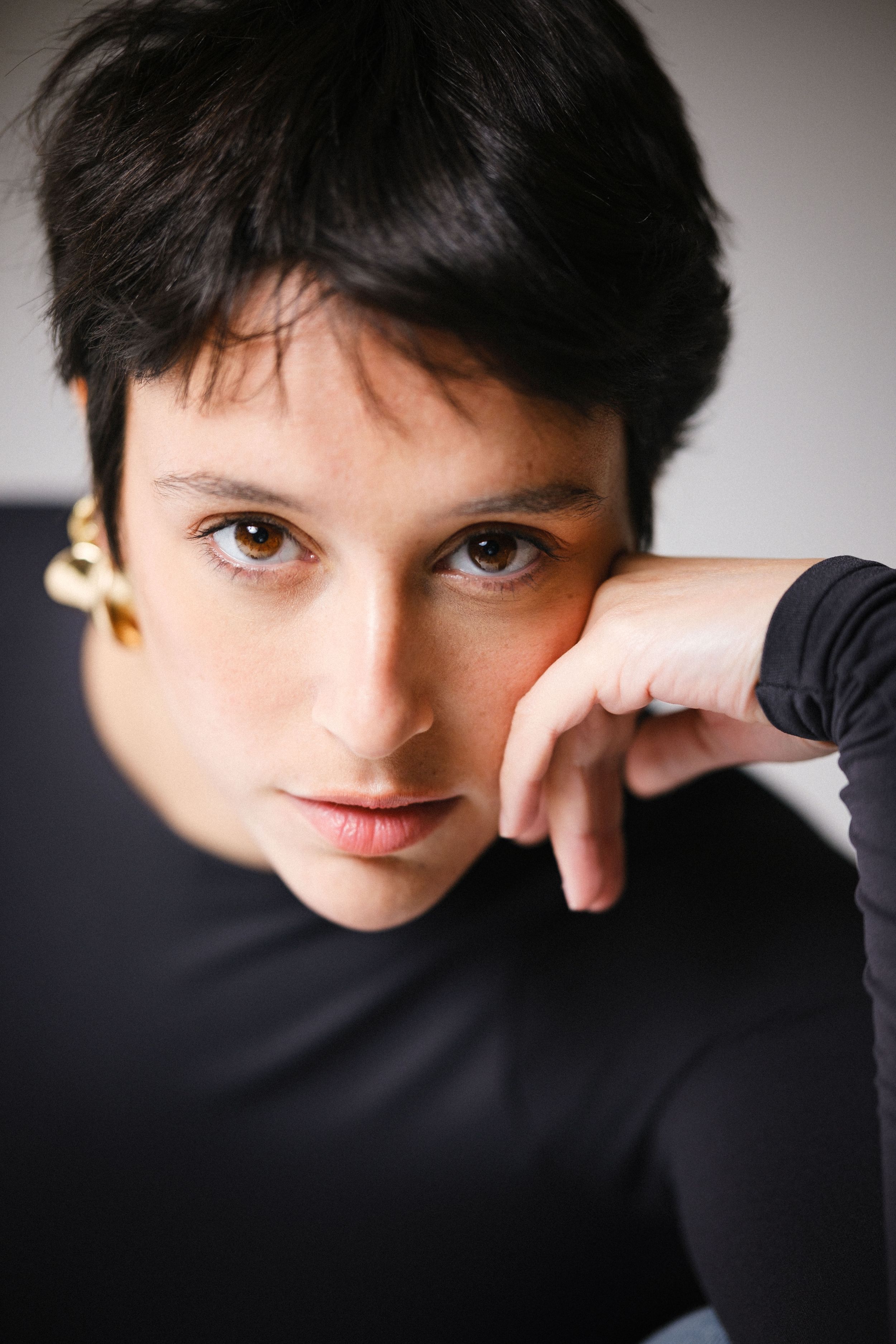 Intimate portrait series showing contemplative poses against neutral studio background.