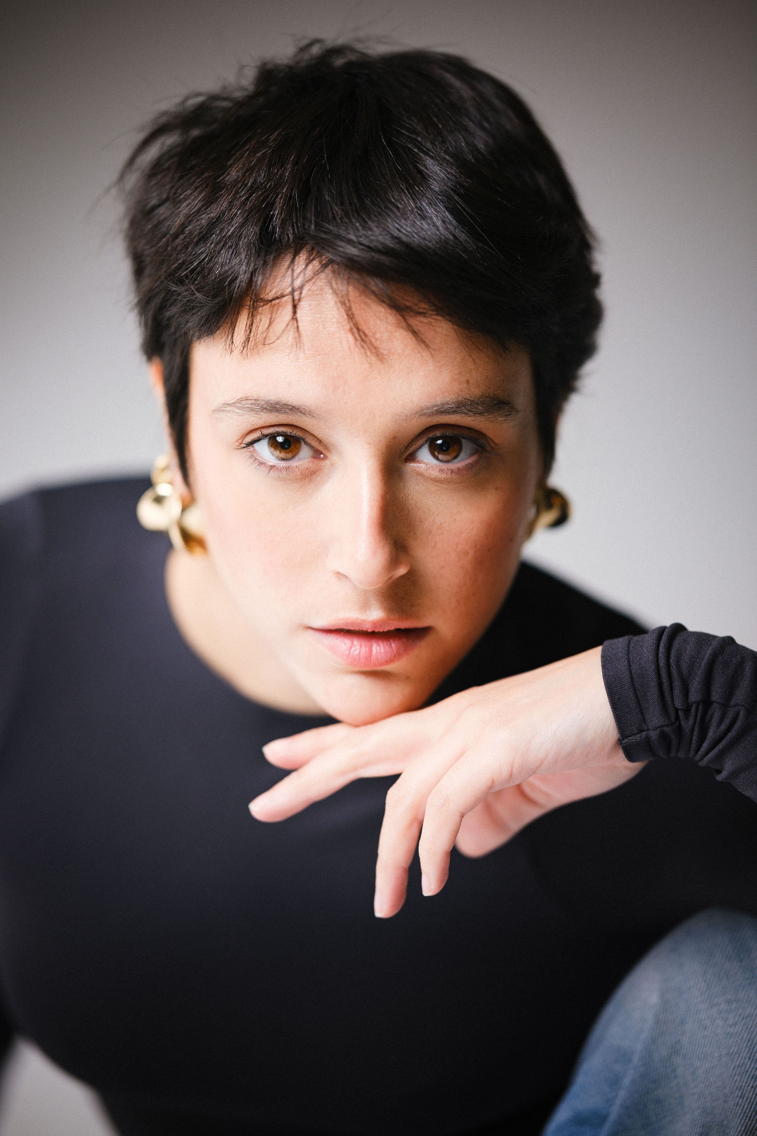 Close-up portrait series featuring dark hair and black turtleneck in studio lighting.