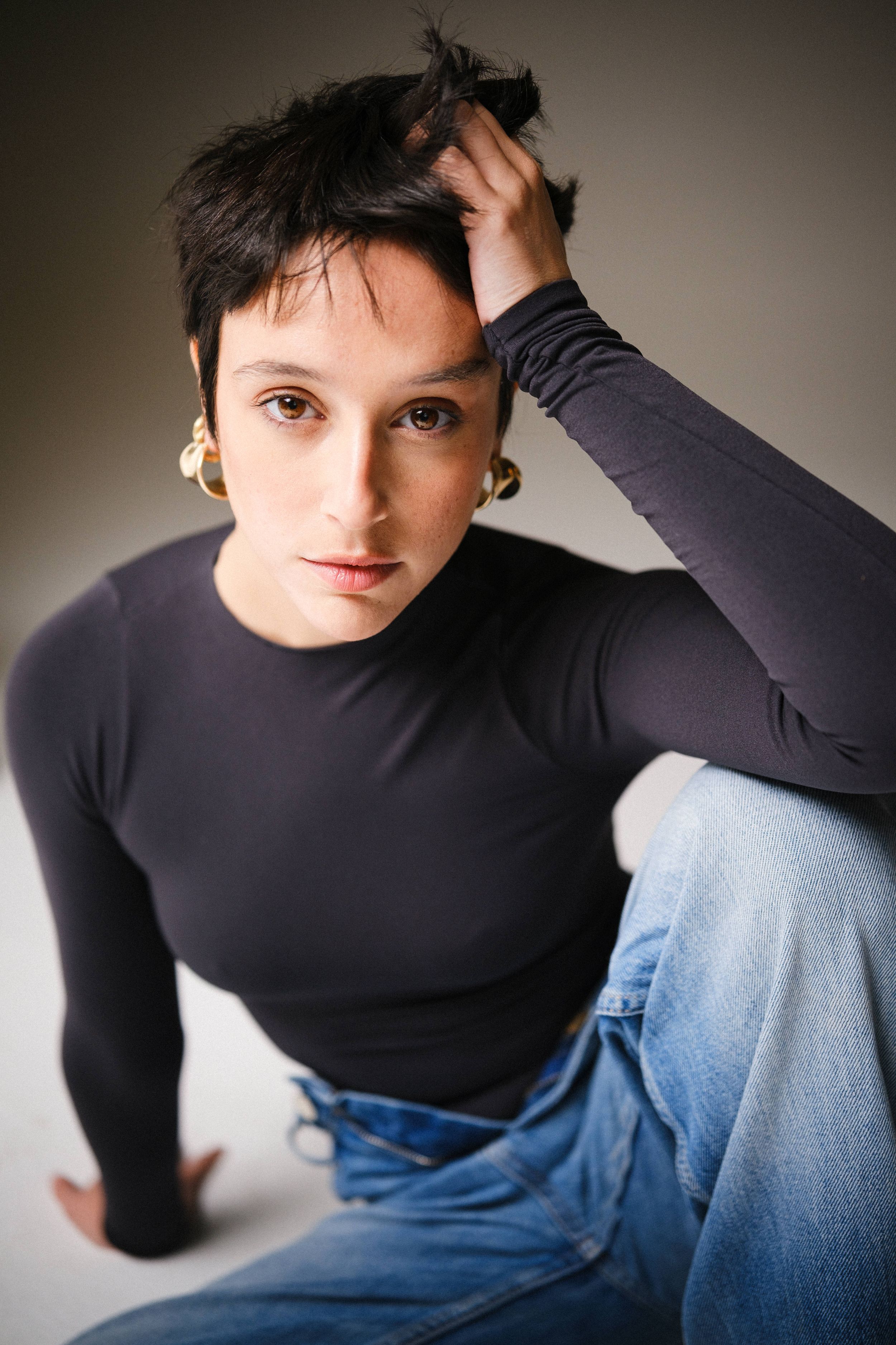 Dramatic studio lighting highlights casual modern fashion styling.