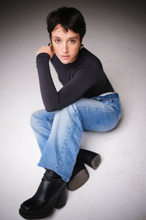 Casual fashion portrait with chunky black boots and relaxed denim.